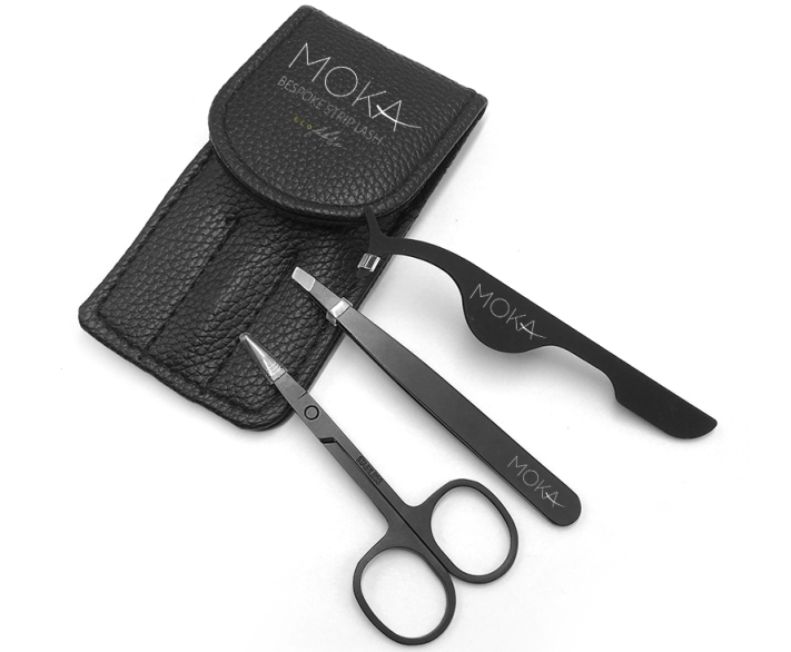 A picture of scissors, tweezers and eyelash application tweezers with the pouch that houses them.