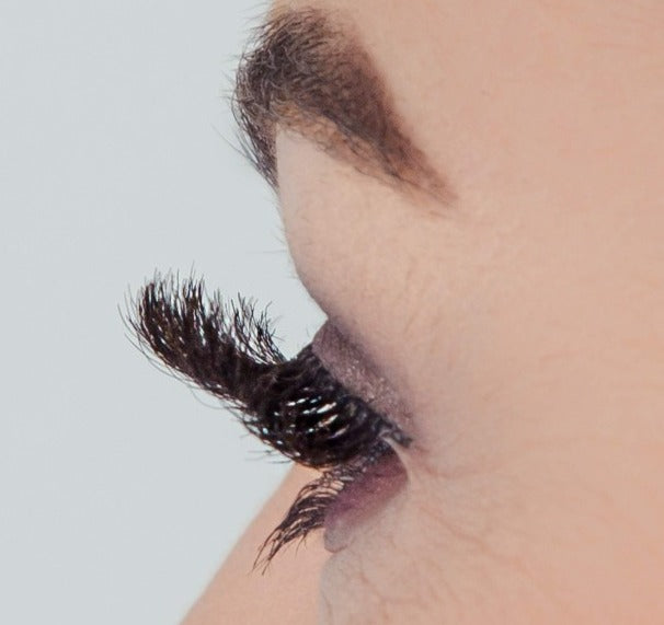 Side profile close up image of a models eye wearing luxurious Moka Bespoke Strip Lashes